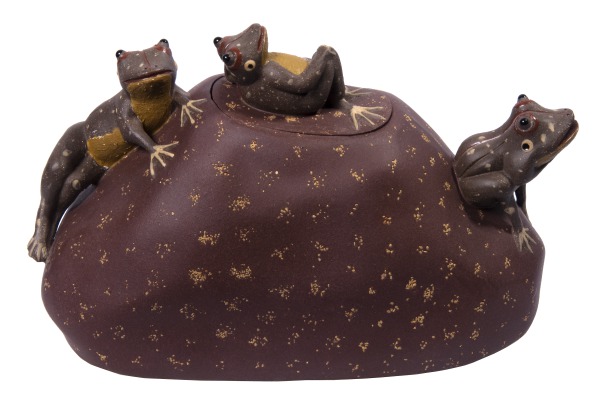 Rock-like teapot with three frogs